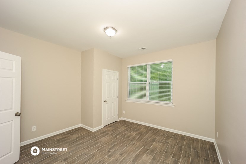 an empty room with a door and a window