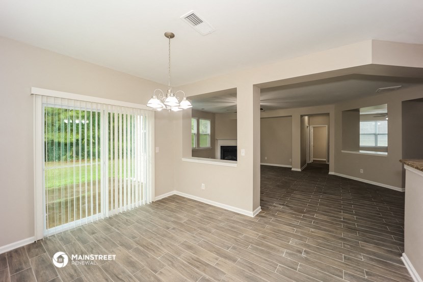 an empty living room with a sliding glass door