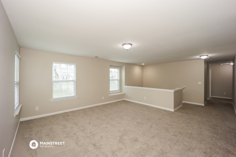 the living room and dining room of an empty house