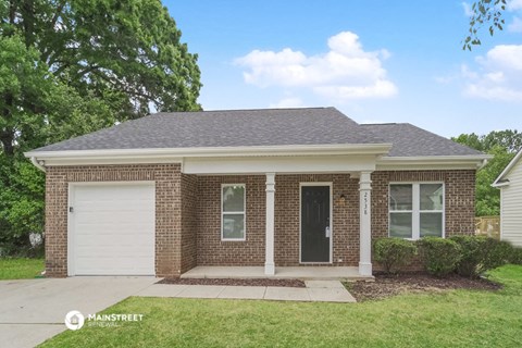 a brick house with a white garage door