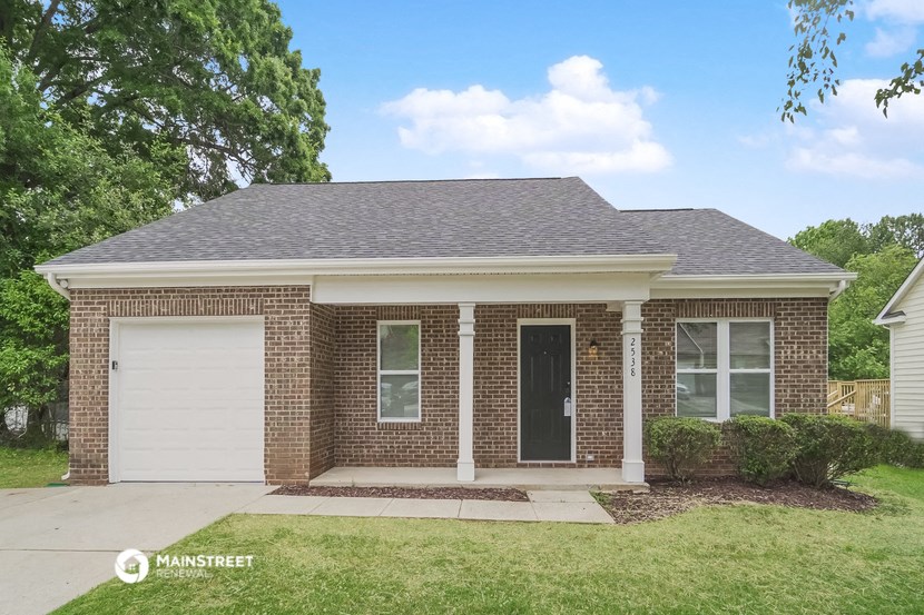 a brick house with a white garage door
