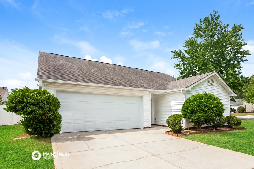 a white garage door in front of a white house