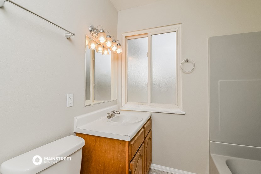 a bathroom with a sink and a mirror and a tub