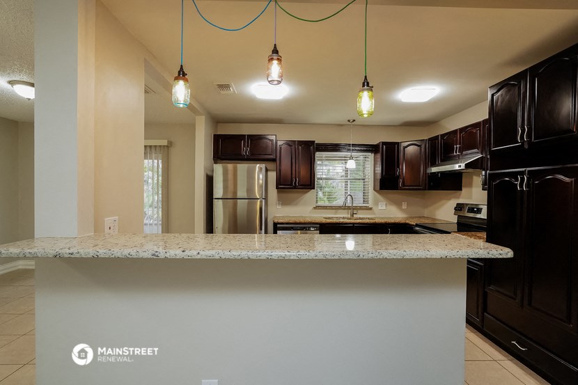 a kitchen with black appliances and a granite counter top