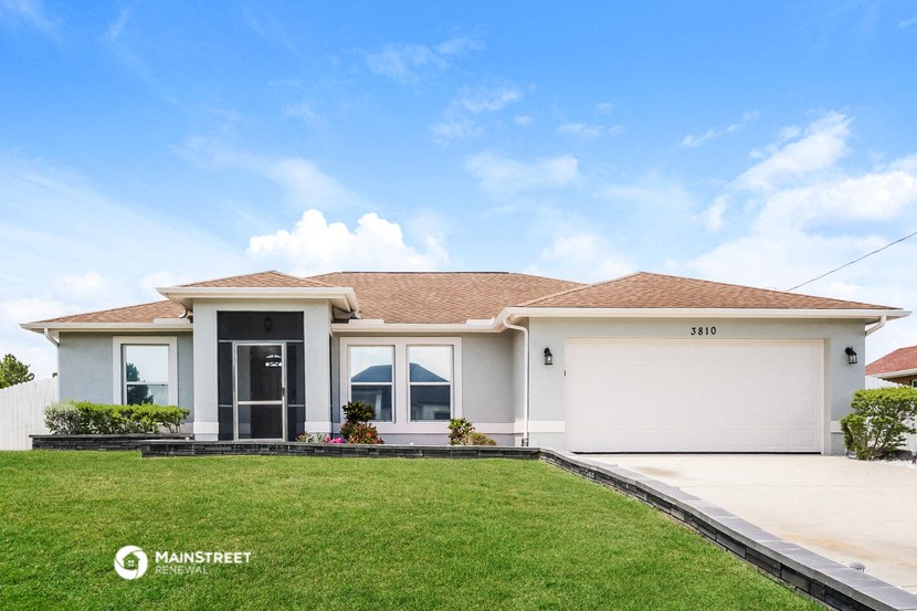 a white house with a lawn in front of it