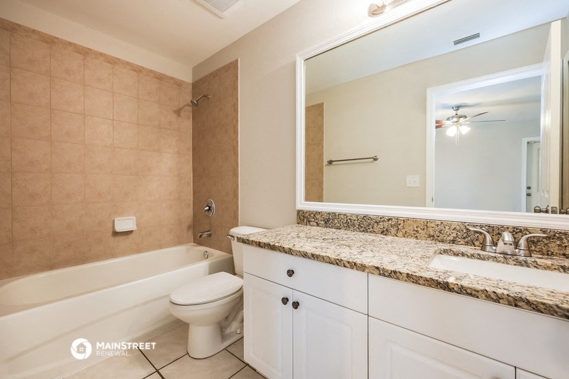 a bathroom with a sink and a toilet and a bath tub
