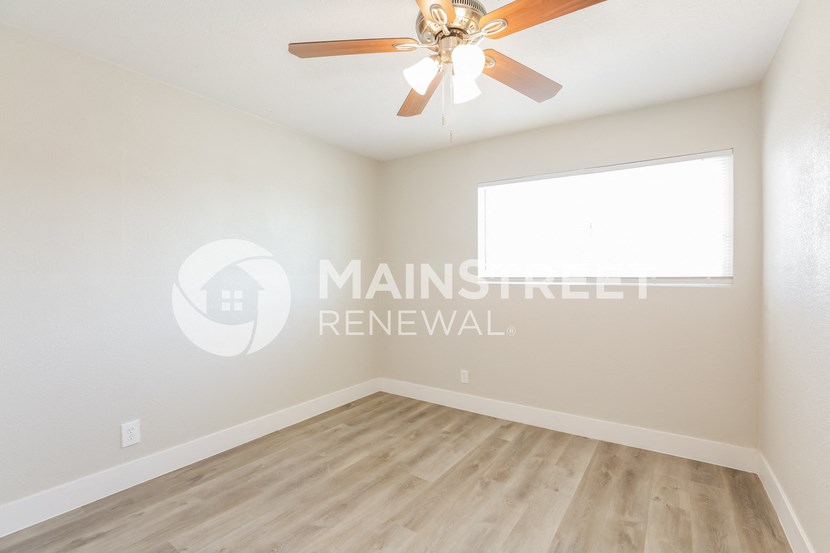 two bedroom apartment with a ceiling fan and a window