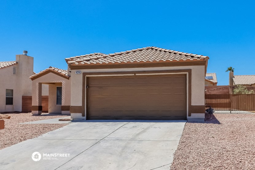a home with a garage door and a driveway