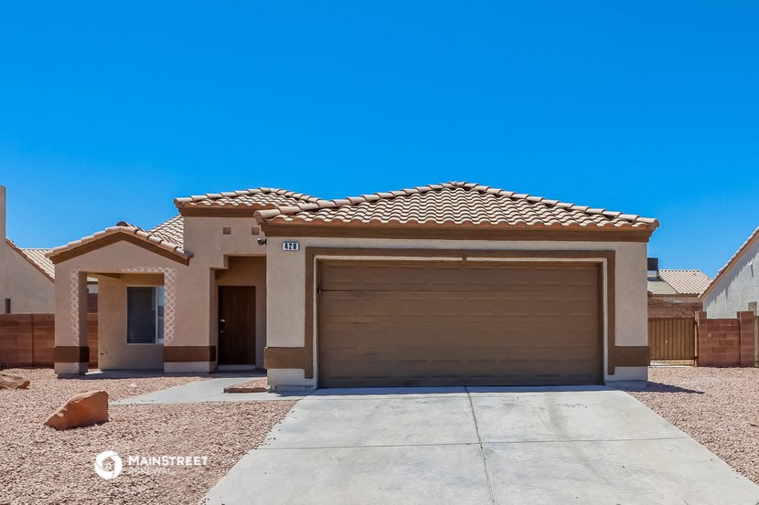 a home with a garage door and a driveway