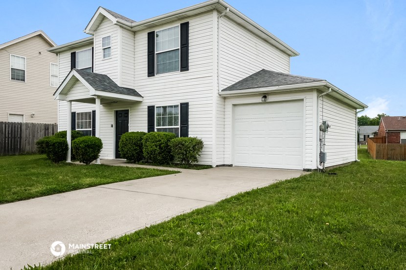 a white house with a sidewalk in front of it