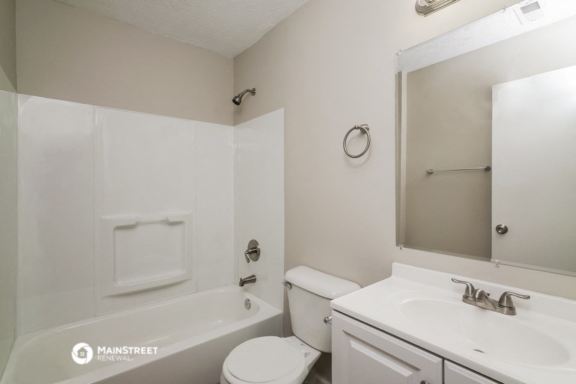 a bathroom with a sink toilet and a bath tub