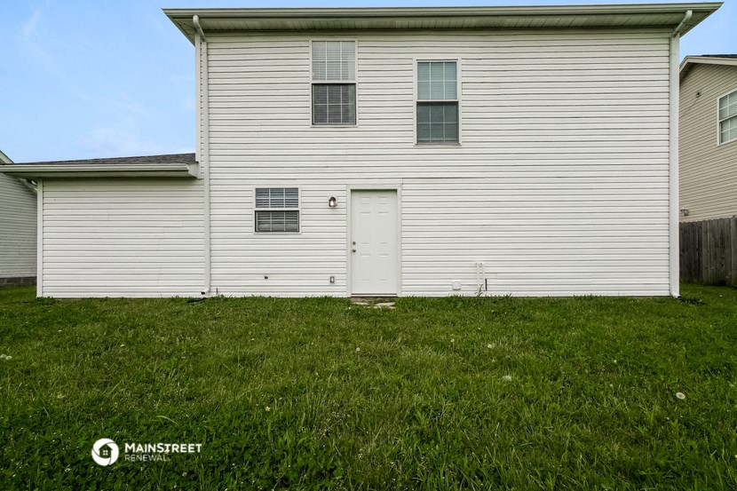 the side of a white house with a white door
