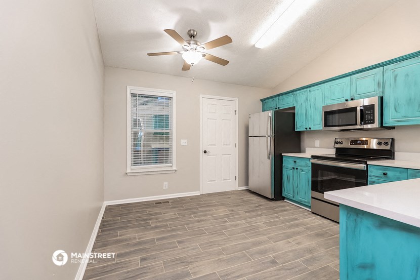 the kitchen of our studio apartment atrium with stainless steel appliances and blue cabinets