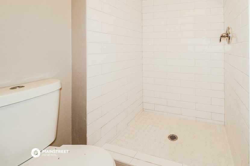 a small bathroom with a toilet and a shower