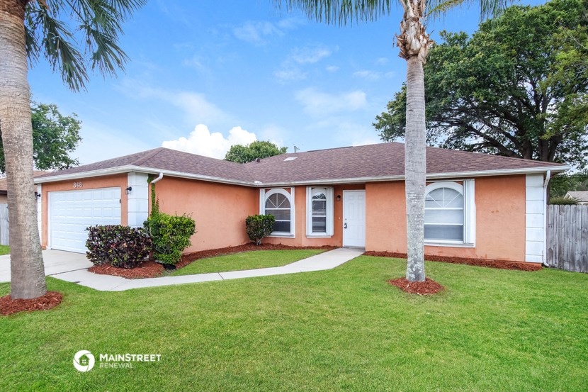 a pink house with a palm tree in front of it