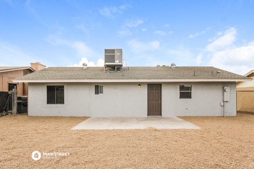 a small white house with a roof and a solar panel on the roof