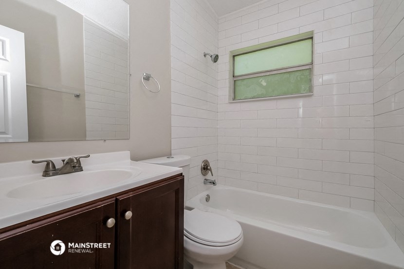a bathroom with a sink and a toilet and a bath tub