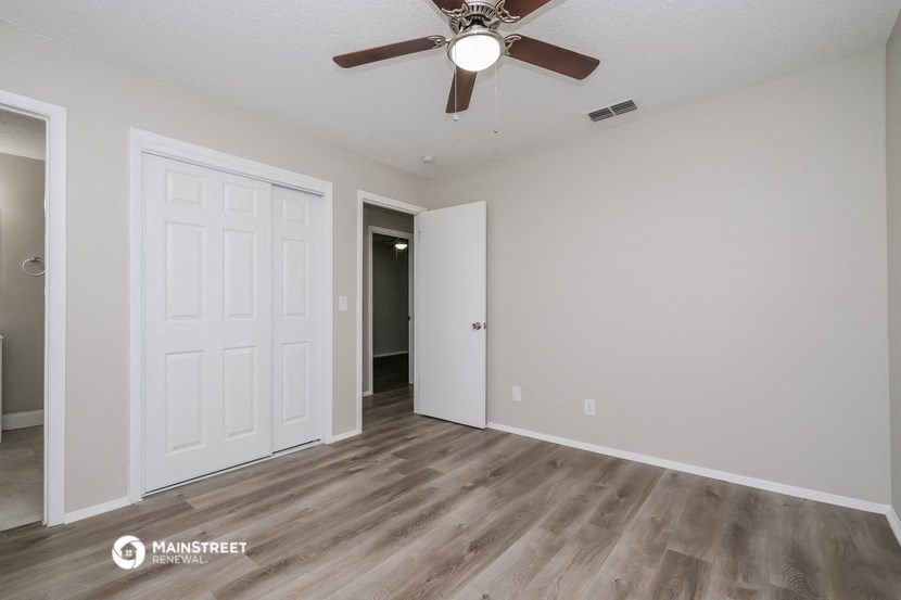 the living room of our studio apartment atrium with a ceiling fan