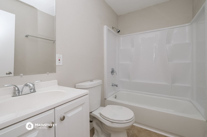 a bathroom with a sink toilet and a tub