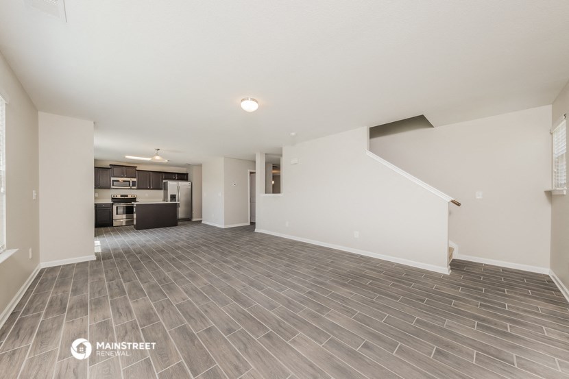 the living room and kitchen of an apartment