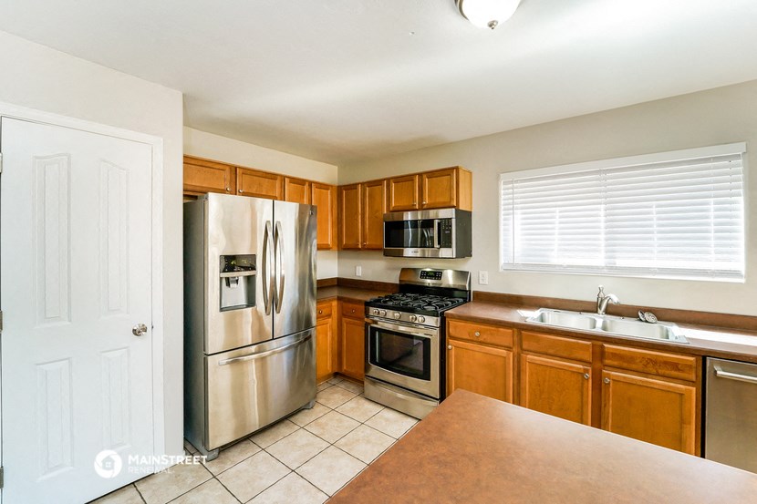 a kitchen with stainless steel appliances and wooden cabinets