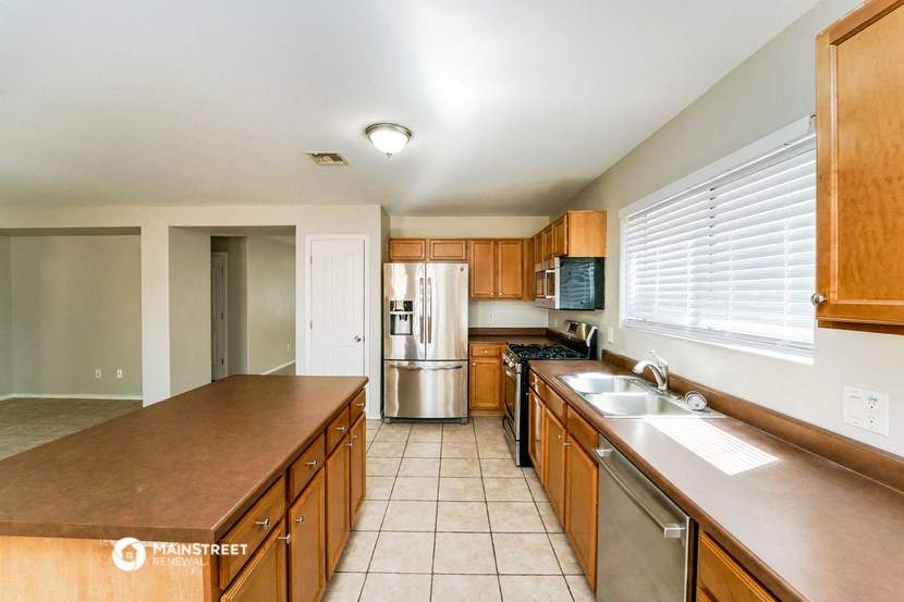 a kitchen with wooden cabinets and stainless steel appliances