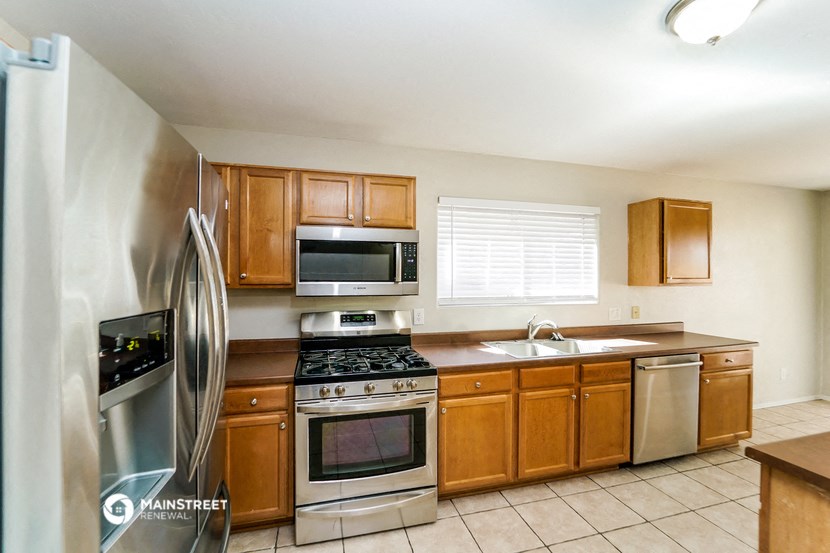 a kitchen with stainless steel appliances and wooden cabinets