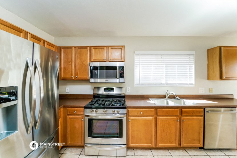 a kitchen with stainless steel appliances and wooden cabinets