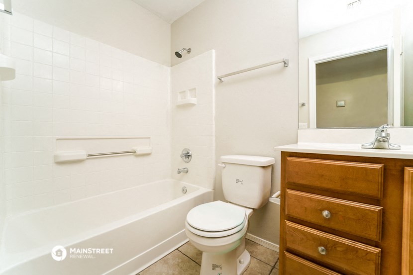 a bathroom with a toilet and a tub and a sink