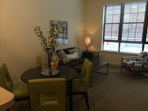 a living room with a table and chairs and a couch