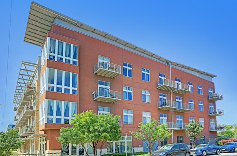 A red building with a balcony on the second floor.