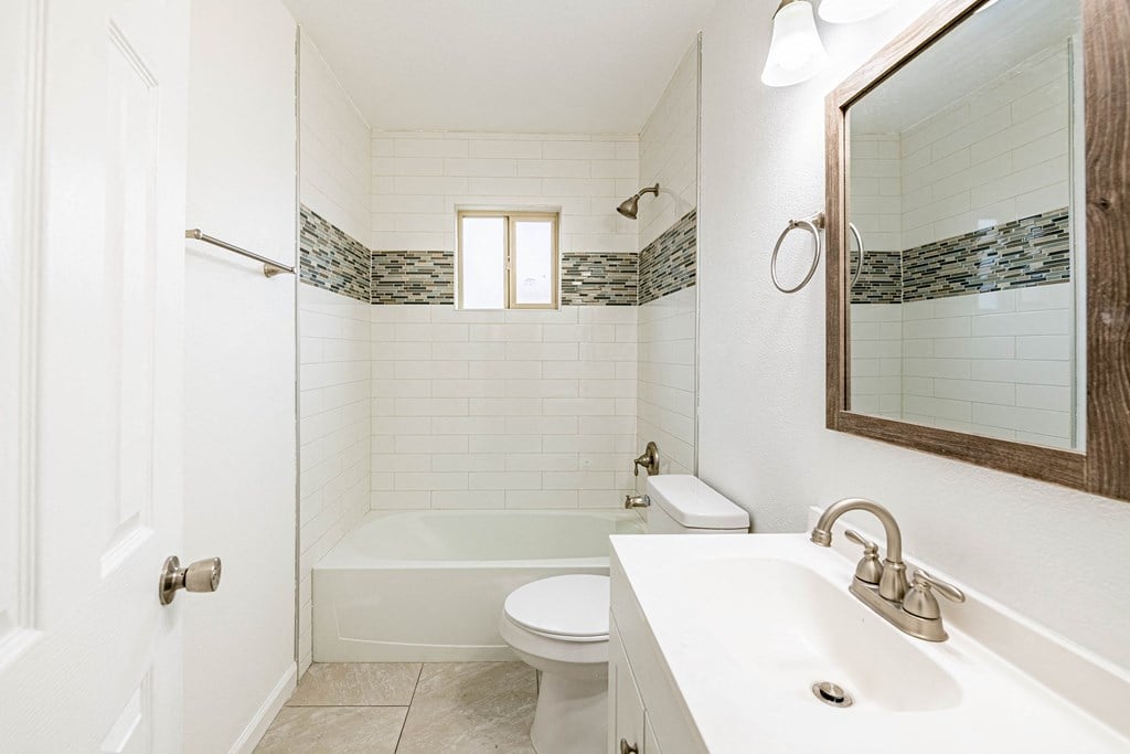 a bathroom with a sink and a toilet and a bath tub