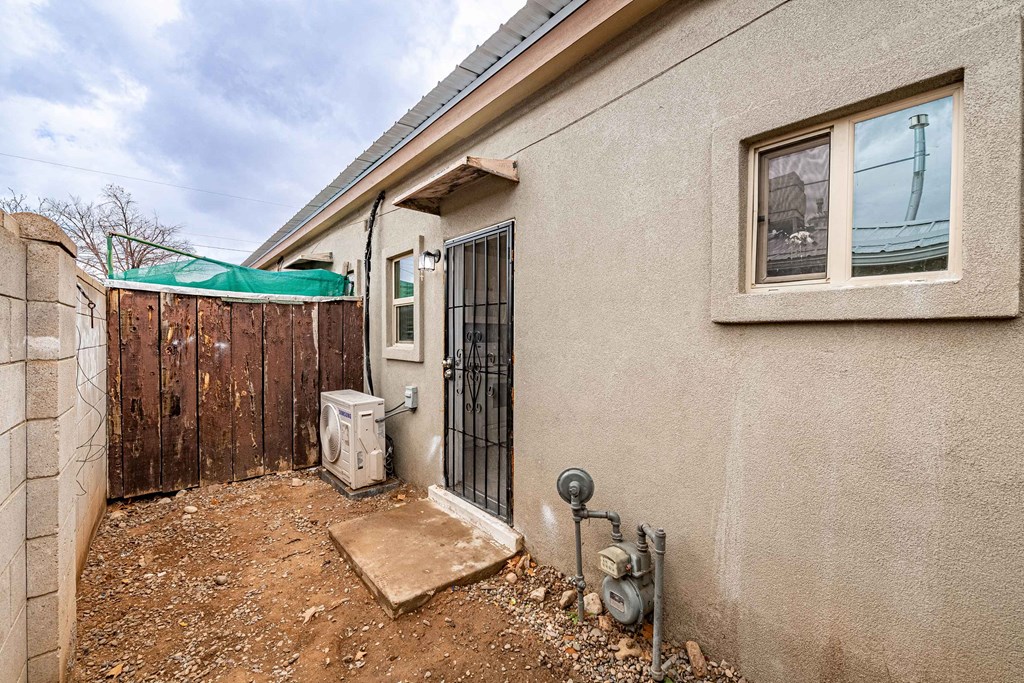 the backyard of a house with a fence and a gate