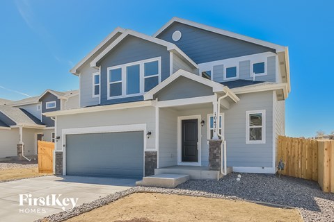 A modern two-story house with a garage is for sale by FirstKey Homes.