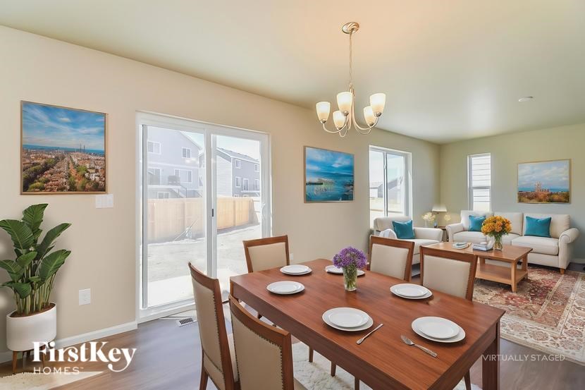 A dining room with a wooden table set for six.