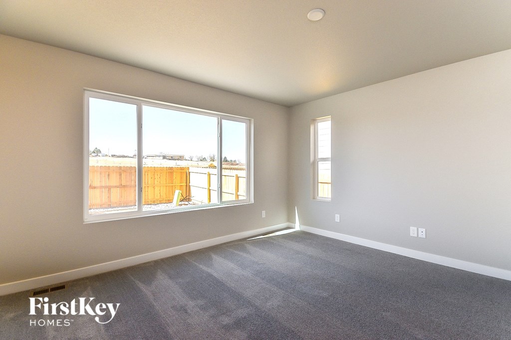 an empty living room with a large window