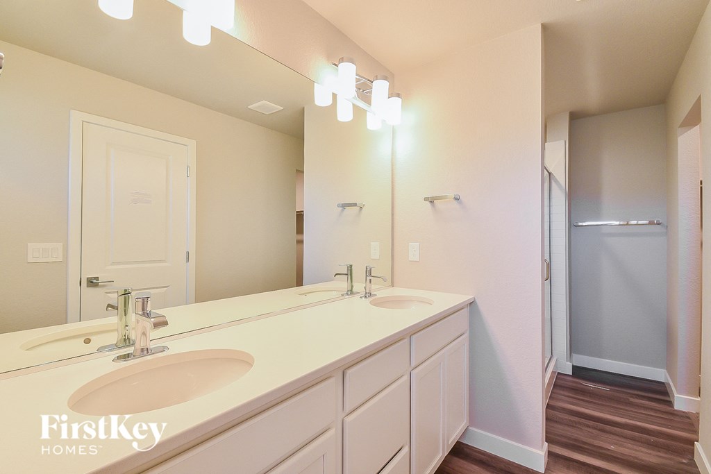 a bathroom with two sinks and a large mirror