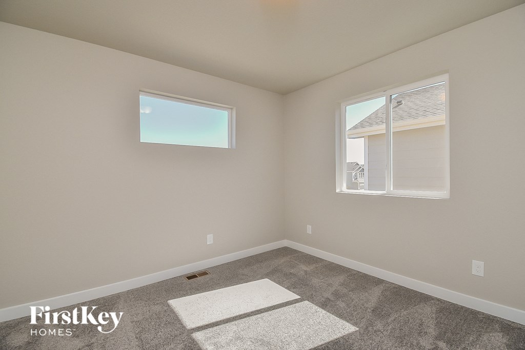 an empty room with carpet and a window