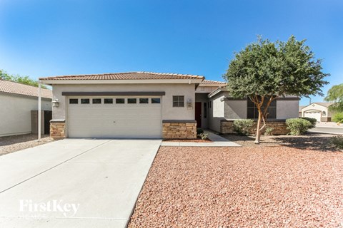 a white house with a driveway and a garage door