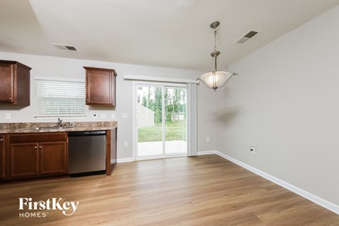A kitchen with wooden cabinets and a marble countertop.