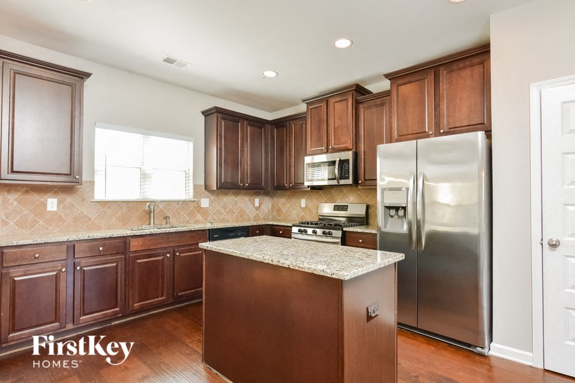 a kitchen with wooden cabinets and stainless steel appliances
