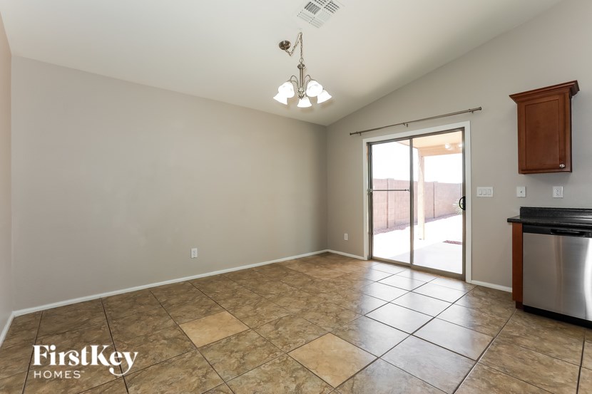 A kitchen area with a tile floor and a stainless steel dishwasher.
