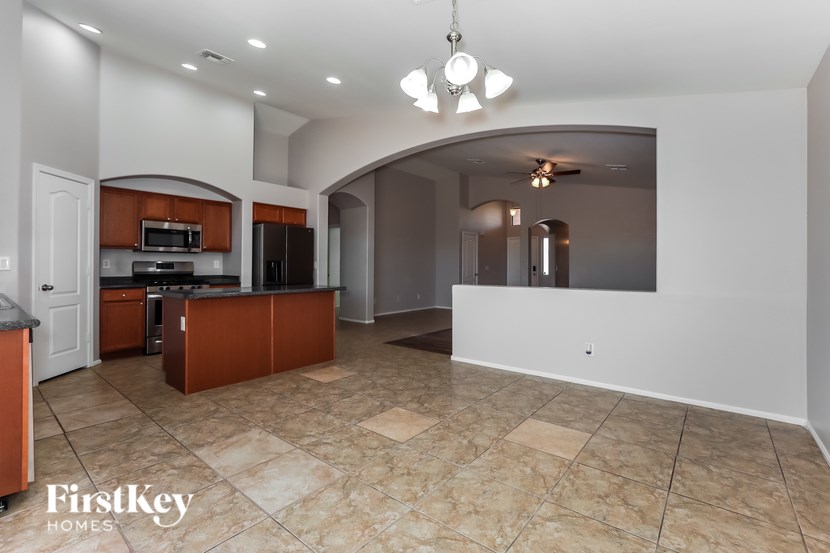 A spacious kitchen with a large island and a dining area.