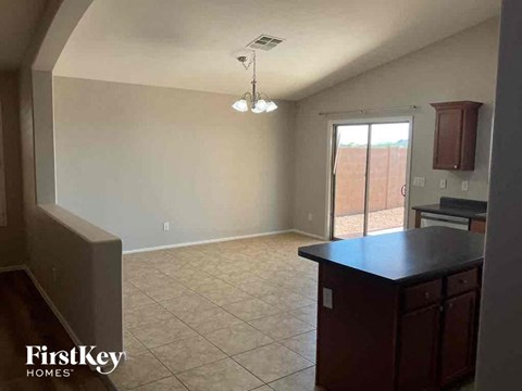 A kitchen area with a black countertop and a FirstKey Homes logo.