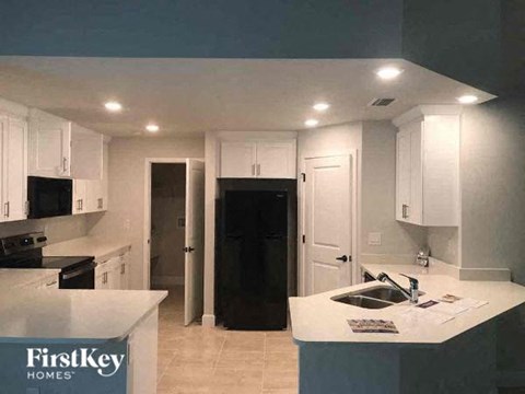 a kitchen with white cabinets and a sink