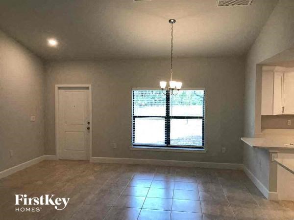 an empty kitchen with a large window and a door