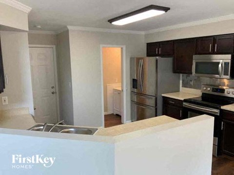 a kitchen with a sink and a refrigerator
