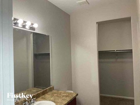 a bathroom with a sink and a mirror and a shower