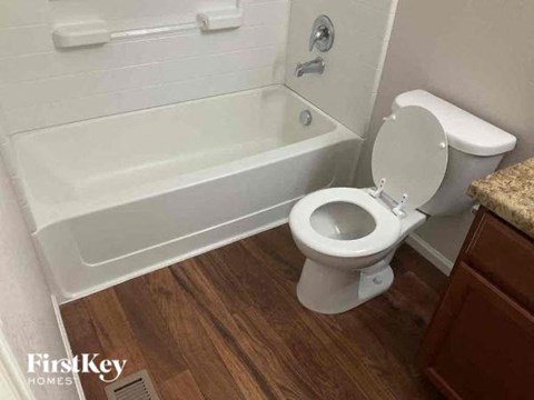 a bathroom with a toilet and a bath tub
