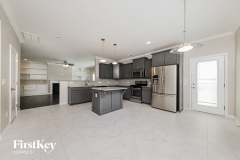 A spacious kitchen with a large island and stainless steel appliances.
